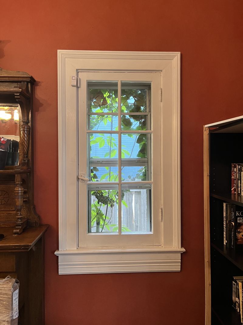 White window in a red-painted room