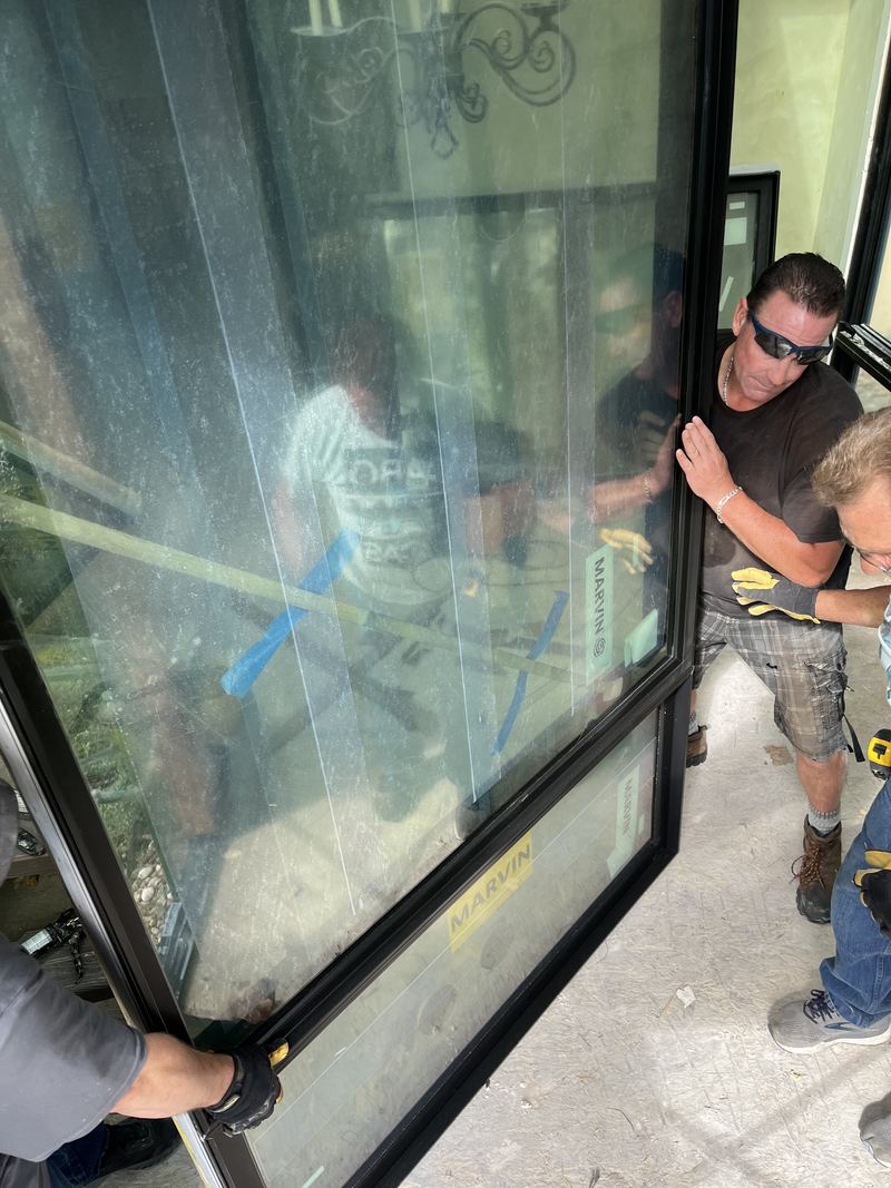 Installer guiding a large glass panel