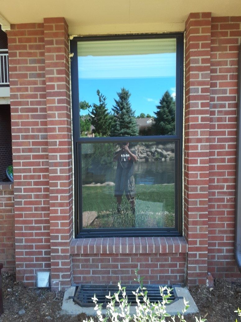 Tall black window on brick